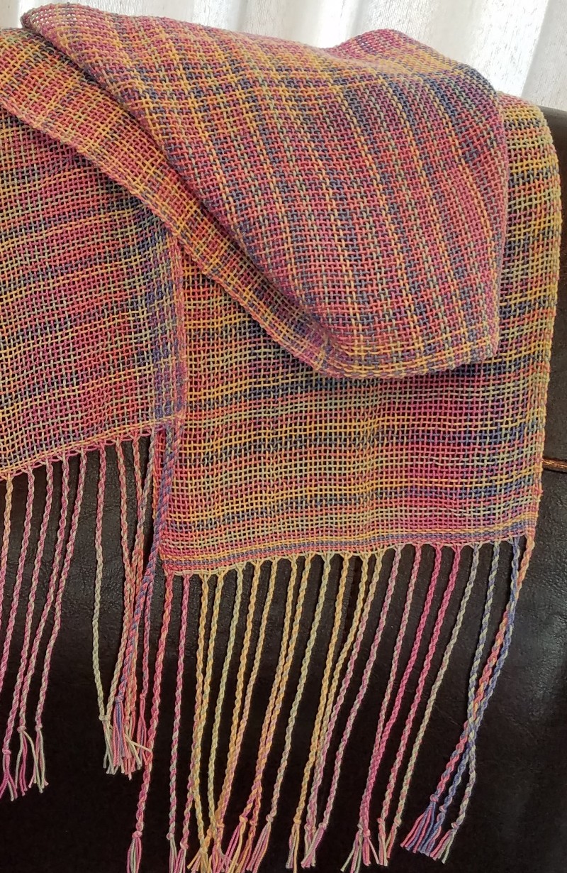 A irredencent pastel scarf, with long fringes.